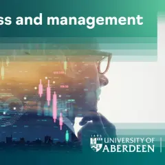 Man in glasses looking at stock market data. Earn your accredited online business administration degree with the University of Aberdeen.