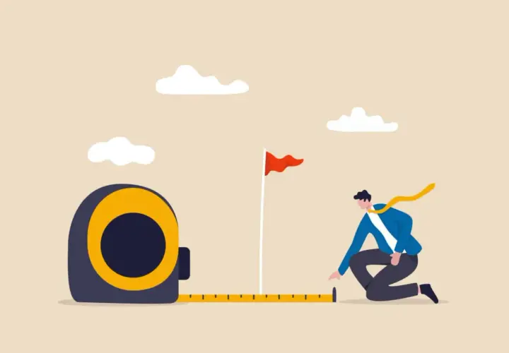A man measures the distance to a goal flag, symbolizing progress and planning at an internal communications conference.