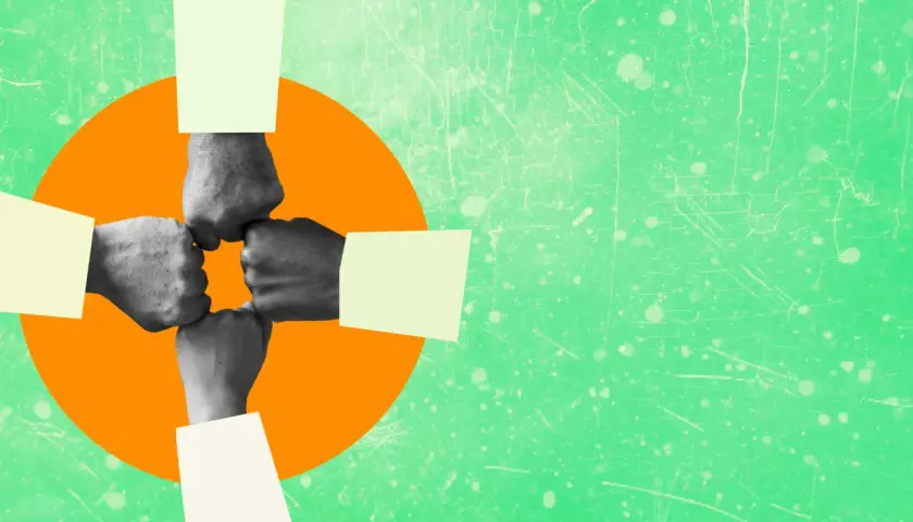 Four fists bump in a circle, symbolizing authentic leadership and teamwork.