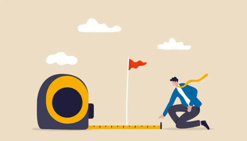 A man measures the distance to a goal flag, symbolizing progress and planning at an internal communications conference.