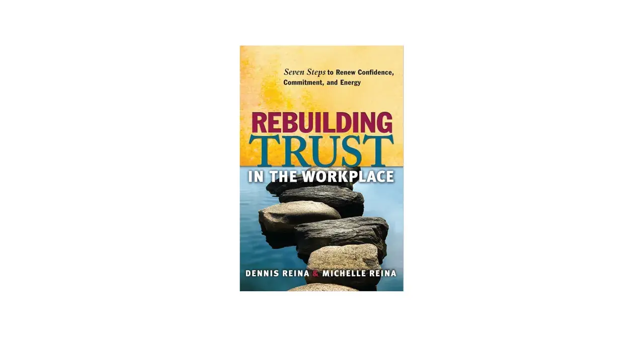 Book cover: "Rebuilding Trust in the Workplace" by Dennis & Michelle Reina. Stacked stones symbolize rebuilding trust.