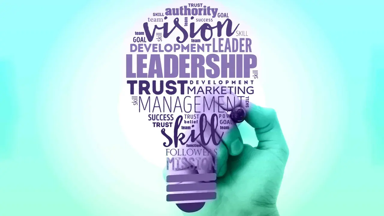 A hand draws a lightbulb filled with words like "Leadership," "Vision," and "Skill," symbolizing effective leadership branding.