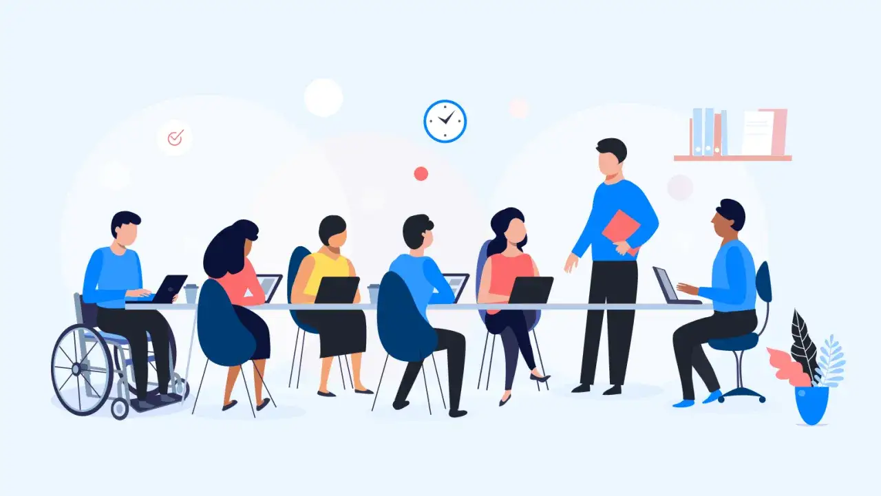 Diverse team collaborating on an internal communication campaign. A person in a wheelchair works alongside colleagues.