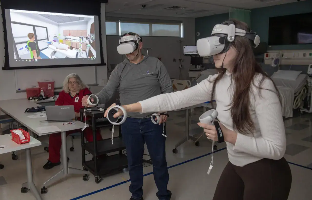 Students in a health care administration online degree program use VR to practice patient care in a simulated hospital room.