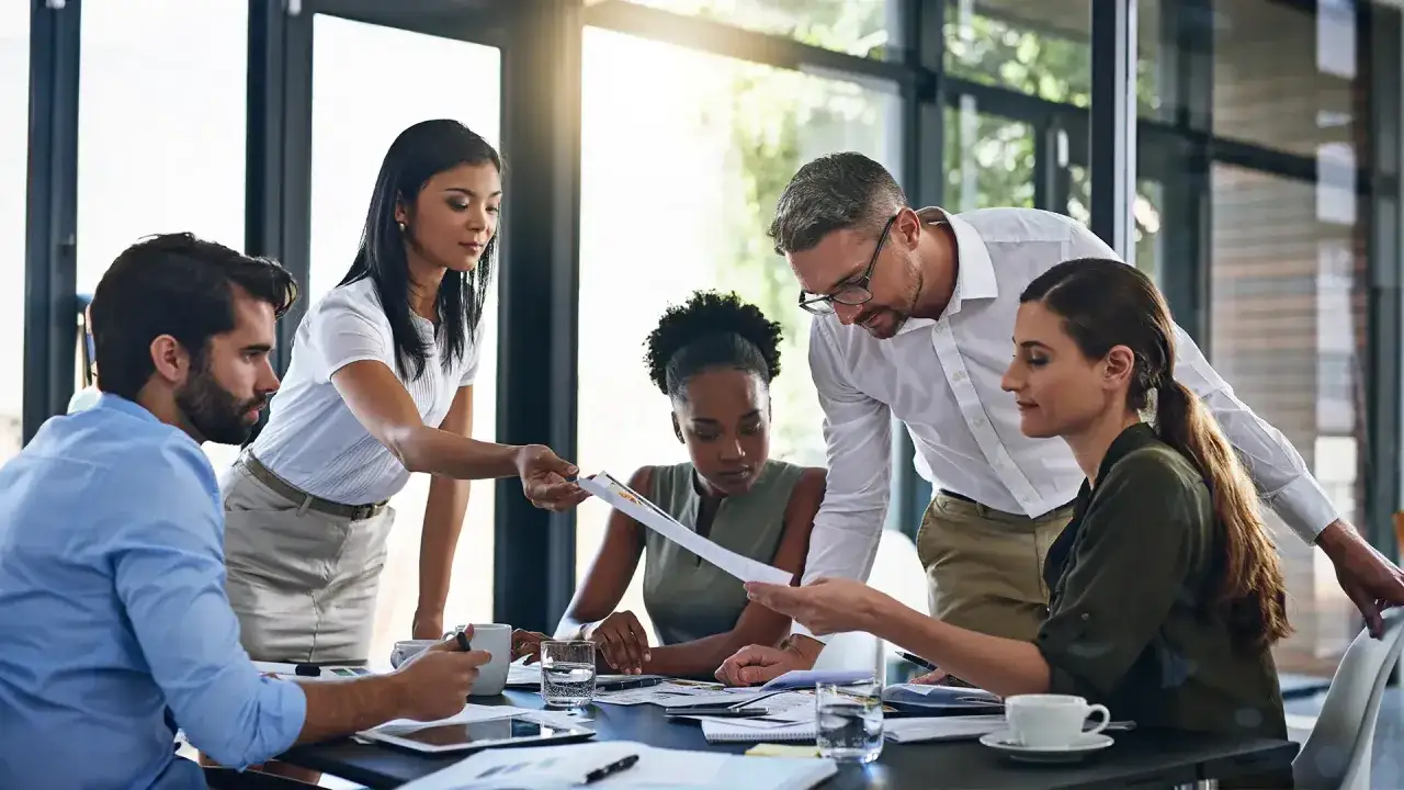 Team members review documents, but their focus seems scattered, hinting at internal noise in communication hindering clarity.