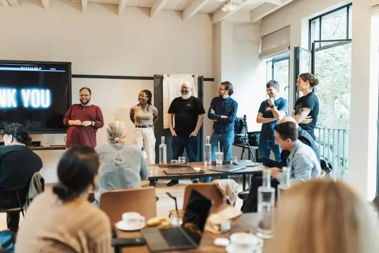 A team celebrates a successful project, showcasing the power of effective comms consultancy.