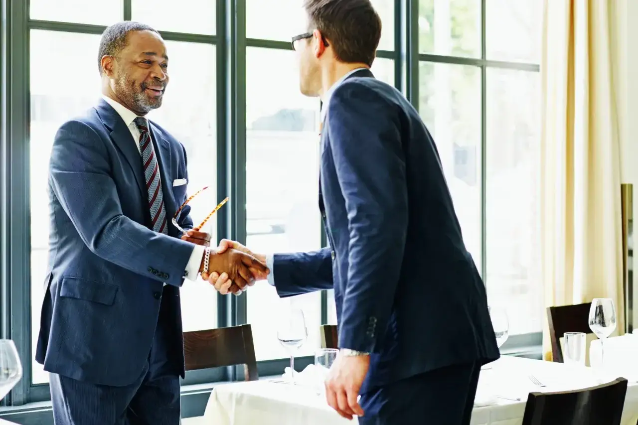 Two businessmen shake hands, a gesture showing why respect is important in building strong relationships and successful ventures.