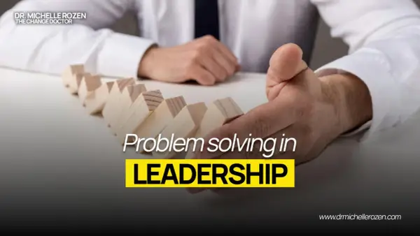 Dr. Michelle Rozen, "The Change Doctor," demonstrates problem-solving in leadership with dominoes. This image is part of leadership coaching news.